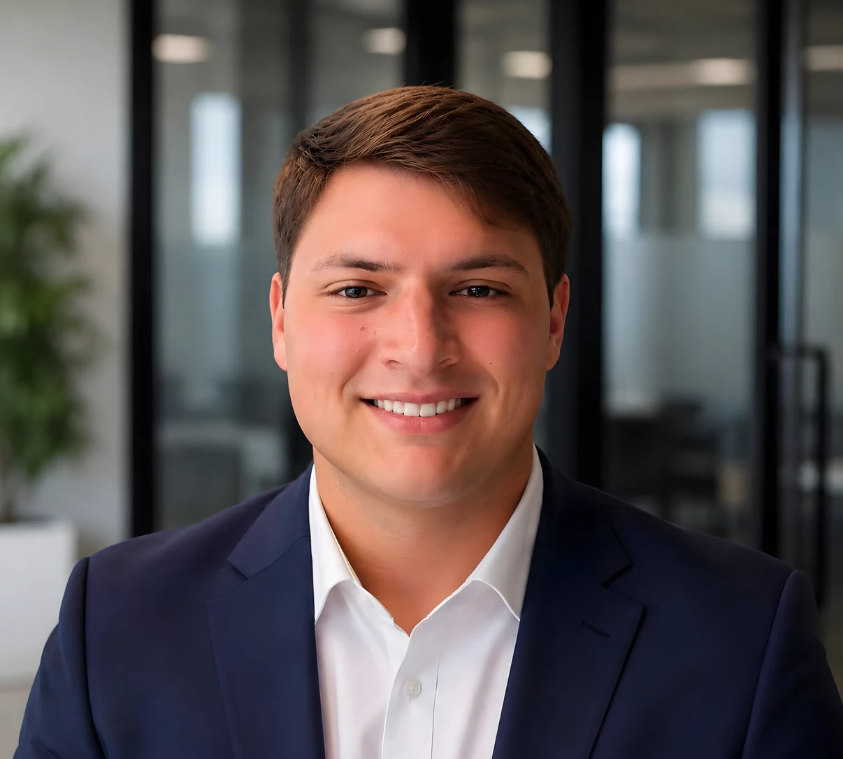 Elias Krupa, smiling in a navy suit and white shirt.